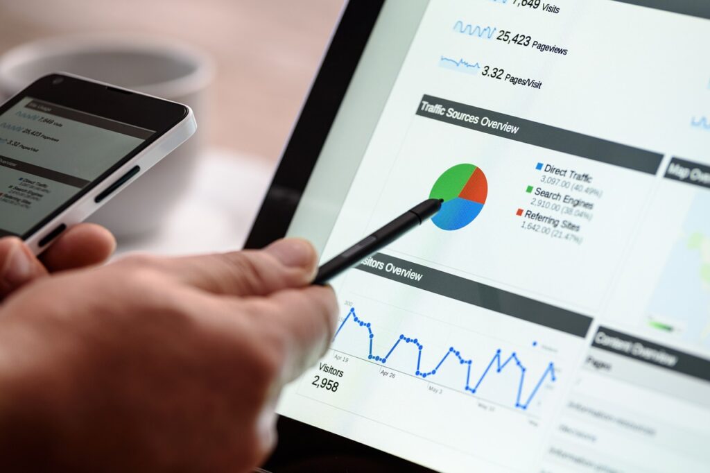 man pointing pen to graph