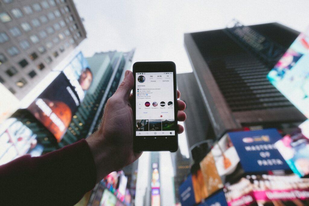 man holding a phone with his social media app
