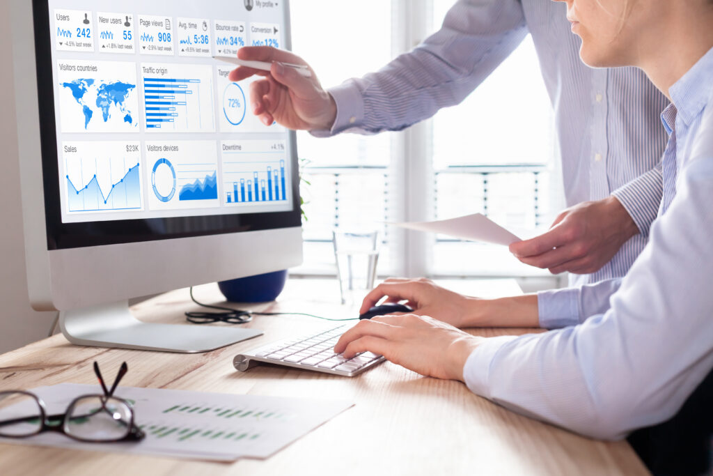 two men analyzing data on a computer