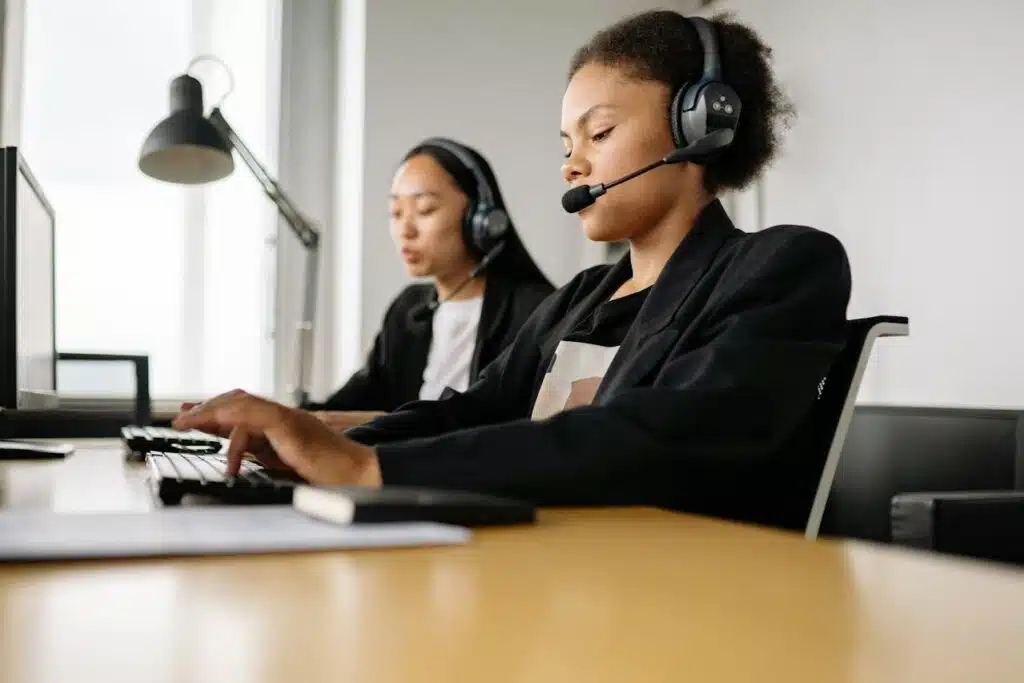 two women in a black suit working on a call center office