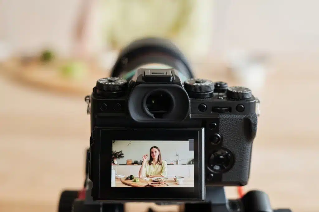 A woman taking a video on digital camera